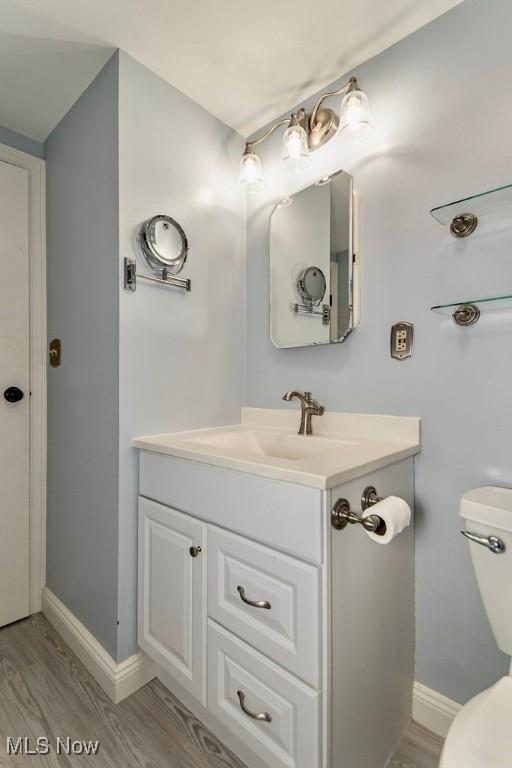 1657 Kasserine Ct, Twinsburg, OH 44087 - half bathroom featuring vanity and wood finished floors