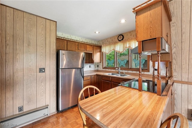 52 Arbor Rd NE, Minerva, OH 44657 - kitchen featuring freestanding refrigerator, a baseboard radiator, brown cabinetry, light countertops, and recessed lighting