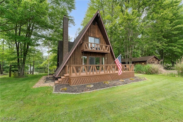 52 Arbor Rd NE, Minerva, OH 44657 - rear view of house featuring a chimney, a lawn, a wooden deck, and a balcony