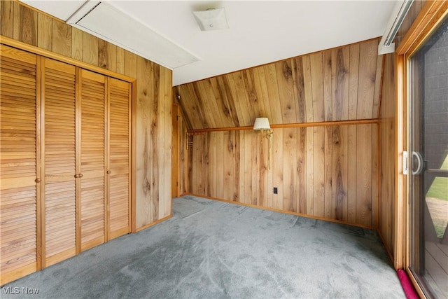 52 Arbor Rd NE, Minerva, OH 44657 - unfurnished bedroom featuring wood walls, carpet flooring, and a closet