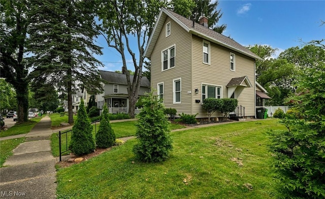 858 11th St NE, Massillon, OH 44646 - view of home's exterior featuring a chimney