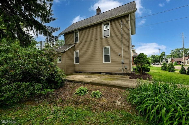 858 11th St NE, Massillon, OH 44646 - back of house featuring a chimney and a patio