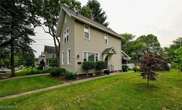 858 11th St NE, Massillon, OH 44646 - view of front of property with a chimney and a front yard