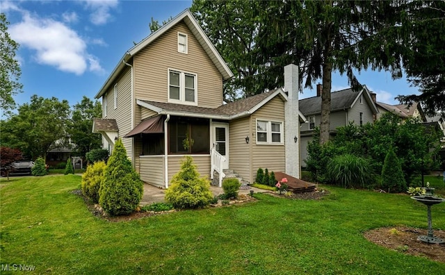 858 11th St NE, Massillon, OH 44646 - back of house featuring entry steps and a yard