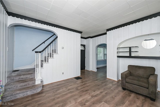 858 11th St NE, Massillon, OH 44646 - unfurnished room with arched walkways, stairs, and wood finished floors