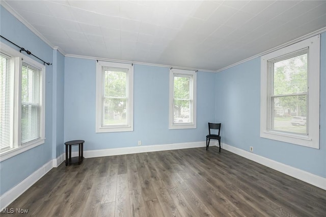 858 11th St NE, Massillon, OH 44646 - empty room featuring dark wood-type flooring, ornamental molding, and plenty of natural light