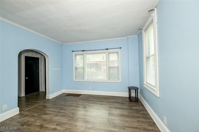 858 11th St NE, Massillon, OH 44646 - unfurnished room with ornamental molding, dark wood-style flooring, and arched walkways
