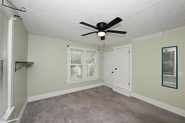 858 11th St NE, Massillon, OH 44646 - empty room with carpet floors, a ceiling fan, and a textured ceiling