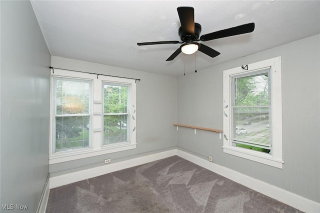 858 11th St NE, Massillon, OH 44646 - empty room with dark carpet and ceiling fan