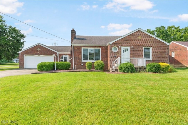 230 Hamilton Blvd, Struthers, OH 44471 - view of front facade featuring a chimney, brick siding, a front lawn, concrete driveway, and an attached garage