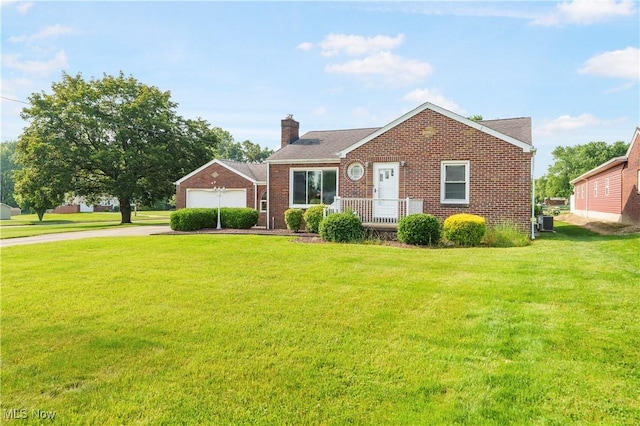 230 Hamilton Blvd, Struthers, OH 44471 - view of front of property featuring driveway, a chimney, a front yard, brick siding, and an attached garage
