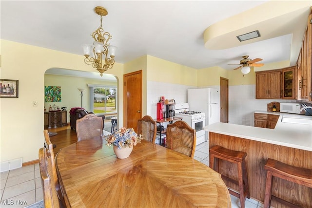 230 Hamilton Blvd, Struthers, OH 44471 - dining room featuring arched walkways, a ceiling fan, light tile patterned floors, and a chandelier