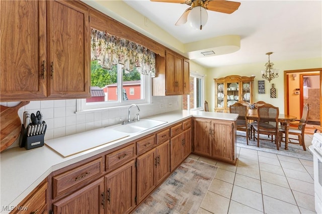 230 Hamilton Blvd, Struthers, OH 44471 - kitchen with brown cabinetry, backsplash, and light countertops