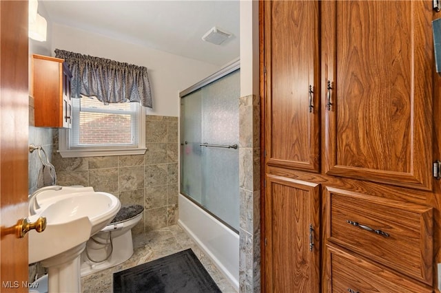230 Hamilton Blvd, Struthers, OH 44471 - bathroom featuring tile walls and shower / bath combination with glass door