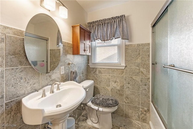 230 Hamilton Blvd, Struthers, OH 44471 - bathroom featuring tile walls, combined bath / shower with glass door, and wainscoting