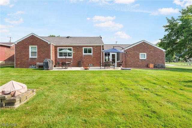 230 Hamilton Blvd, Struthers, OH 44471 - rear view of property with a patio, brick siding, and a lawn