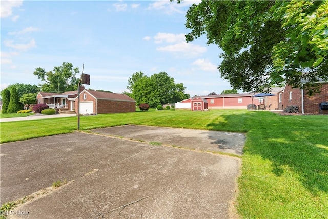 230 Hamilton Blvd, Struthers, OH 44471 - view of grassy yard featuring driveway and a garage