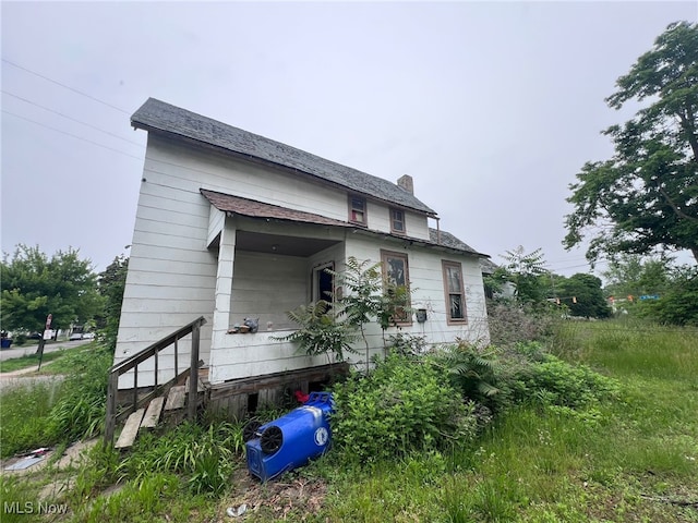 1055 E 78th St, Cleveland, OH 44103 - view of side of property with a chimney
