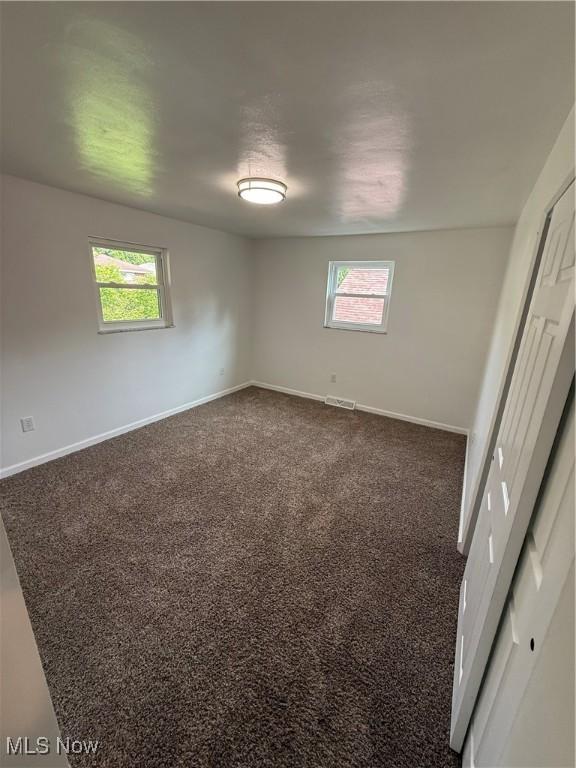 3627 Marland Heights Rd, Weirton, WV 26062 - unfurnished bedroom with multiple windows and dark colored carpet