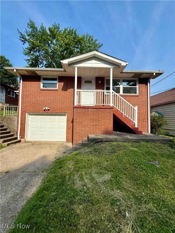 3627 Marland Heights Rd, Weirton, WV 26062 - view of front facade with stairs, driveway, an attached garage, and brick siding