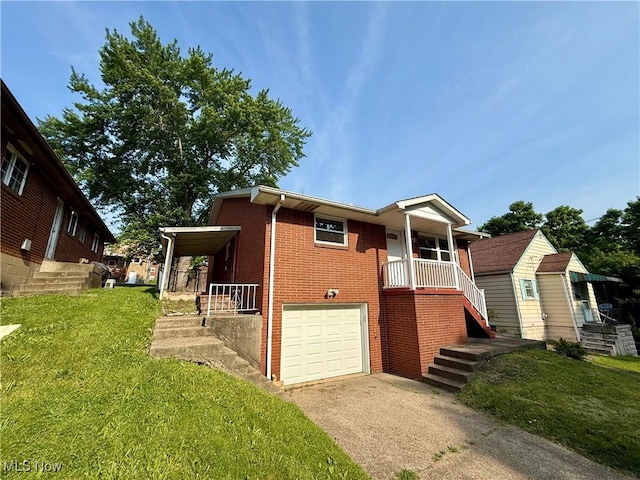 3627 Marland Heights Rd, Weirton, WV 26062 - view of front facade featuring brick siding, driveway, an attached garage, a front lawn, and covered porch