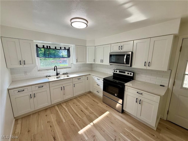3627 Marland Heights Rd, Weirton, WV 26062 - kitchen with stainless steel appliances, light wood-type flooring, and white cabinets