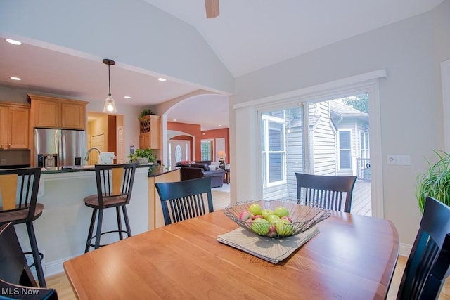 8311 Hemingway Ln, Mentor, OH 44060 - dining room featuring arched walkways, healthy amount of natural light, lofted ceiling, recessed lighting, and light wood-style floors