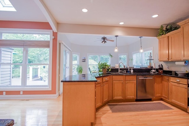 8311 Hemingway Ln, Mentor, OH 44060 - kitchen with stainless steel dishwasher, light wood finished floors, a peninsula, ceiling fan, and dark stone countertops