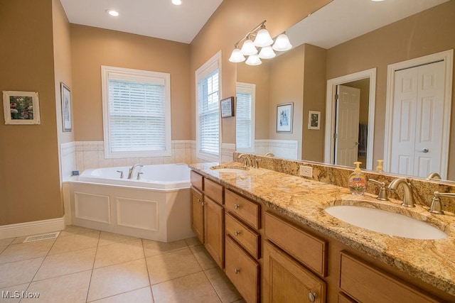 8311 Hemingway Ln, Mentor, OH 44060 - full bathroom with a garden tub, double vanity, and tile patterned flooring