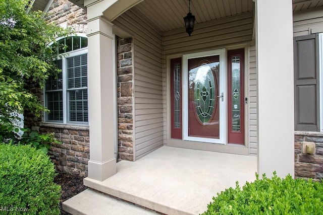 8311 Hemingway Ln, Mentor, OH 44060 - property entrance featuring stone siding and covered porch