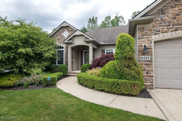 8311 Hemingway Ln, Mentor, OH 44060 - traditional home featuring stone siding, an attached garage, and a front yard
