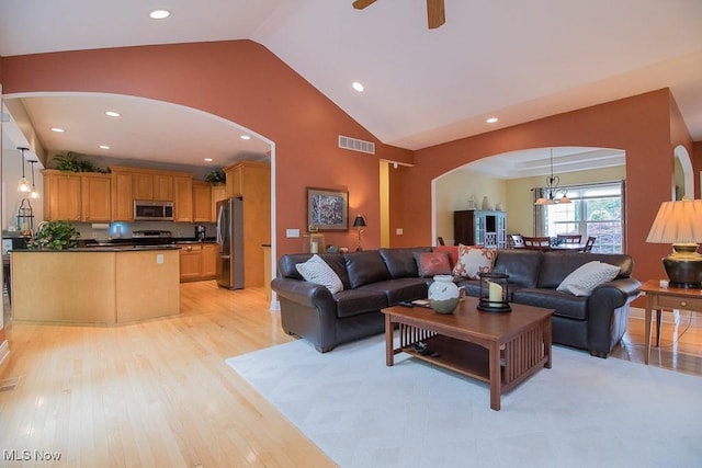 8311 Hemingway Ln, Mentor, OH 44060 - living room with arched walkways, light wood-style floors, a ceiling fan, recessed lighting, and a chandelier
