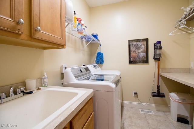 8311 Hemingway Ln, Mentor, OH 44060 - washroom featuring cabinet space, washing machine and clothes dryer, and light tile patterned flooring