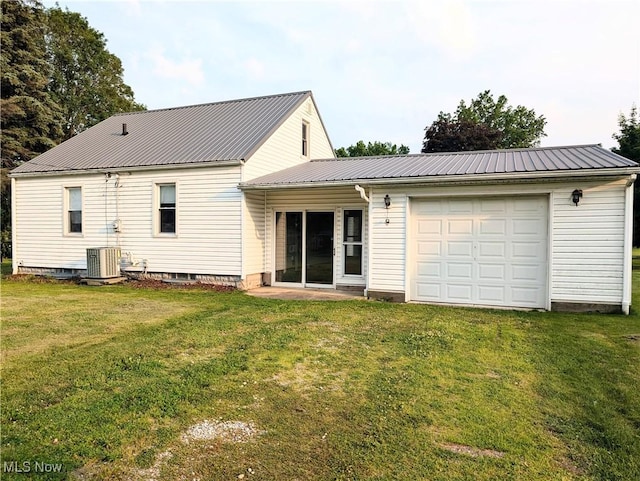 173 6th St SW, Brewster, OH 44613 - back of property featuring a metal roof, a garage, and a yard