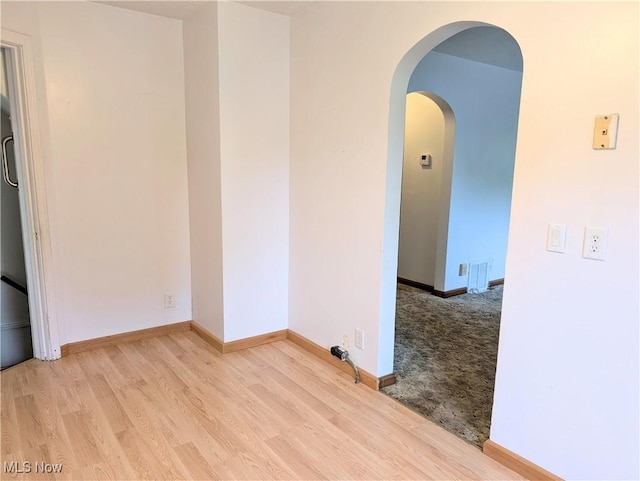 173 6th St SW, Brewster, OH 44613 - spare room featuring wood finished floors and arched walkways