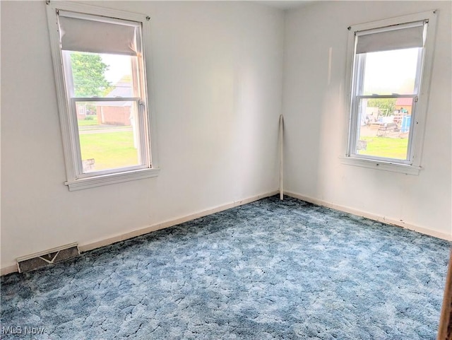 173 6th St SW, Brewster, OH 44613 - empty room featuring carpet flooring and plenty of natural light