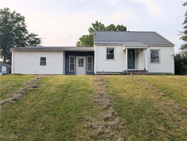 173 6th St SW, Brewster, OH 44613 - view of front of home featuring a front lawn and a metal roof