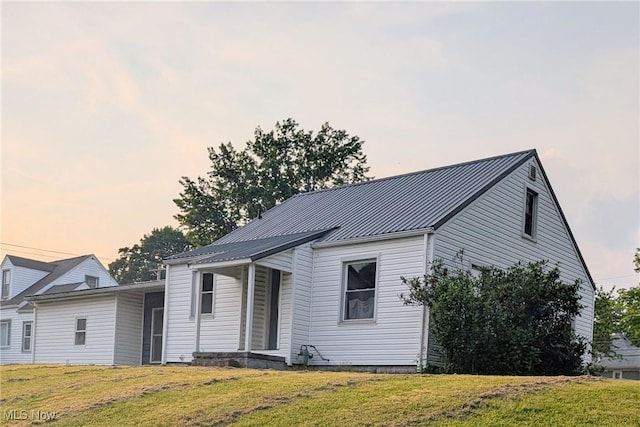 173 6th St SW, Brewster, OH 44613 - view of front of property with a front lawn, a metal roof, and a standing seam roof