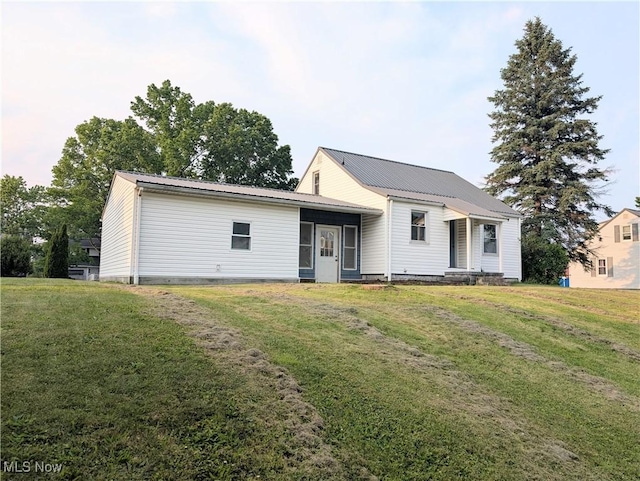 173 6th St SW, Brewster, OH 44613 - back of property with a lawn and a metal roof