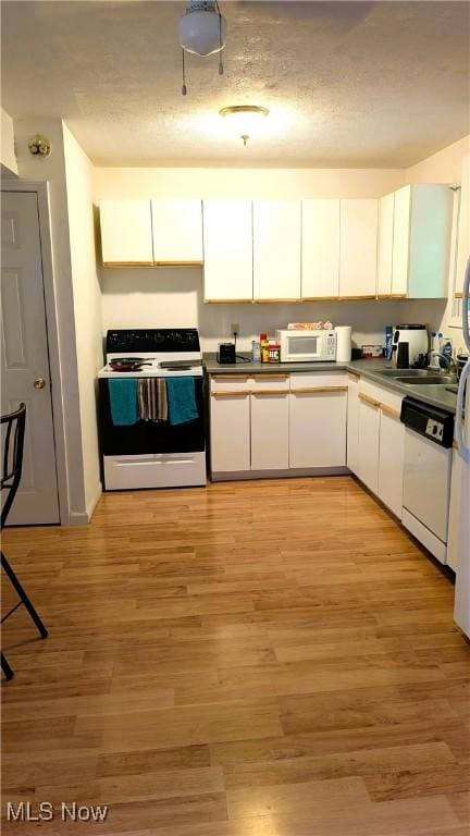 37 Alaska Ave, Chester, WV 26034 - kitchen with white appliances, white cabinets, and light wood-style flooring