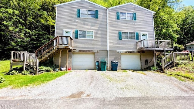 37 Alaska Ave, Chester, WV 26034 - view of front facade featuring stairway, an attached garage, driveway, and a deck