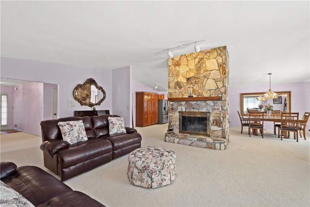 52 Hilda Cir, Bloomingdale, OH 43910 - living room with rail lighting, carpet floors, vaulted ceiling, and a fireplace