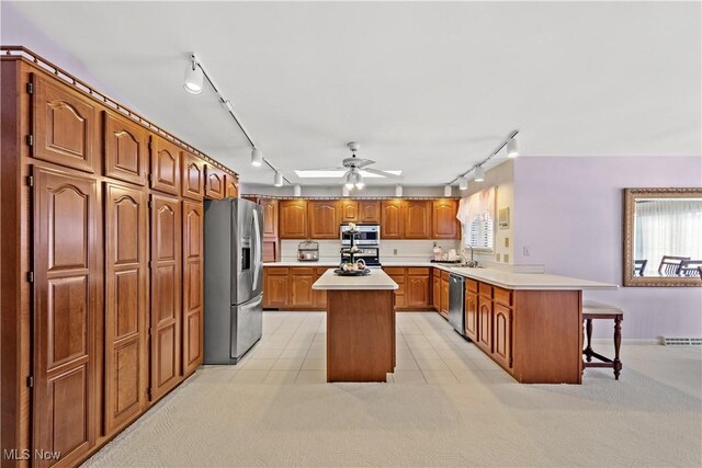 52 Hilda Cir, Bloomingdale, OH 43910 - kitchen with stainless steel appliances, rail lighting, a peninsula, and a kitchen island