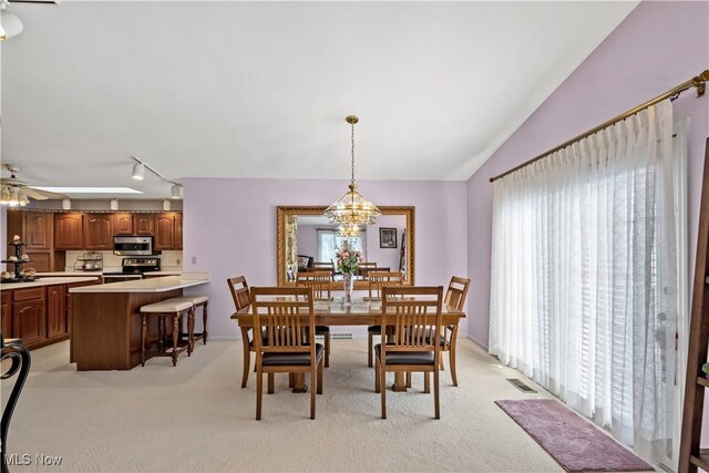 52 Hilda Cir, Bloomingdale, OH 43910 - dining space with light carpet, a chandelier, a ceiling fan, lofted ceiling, and track lighting