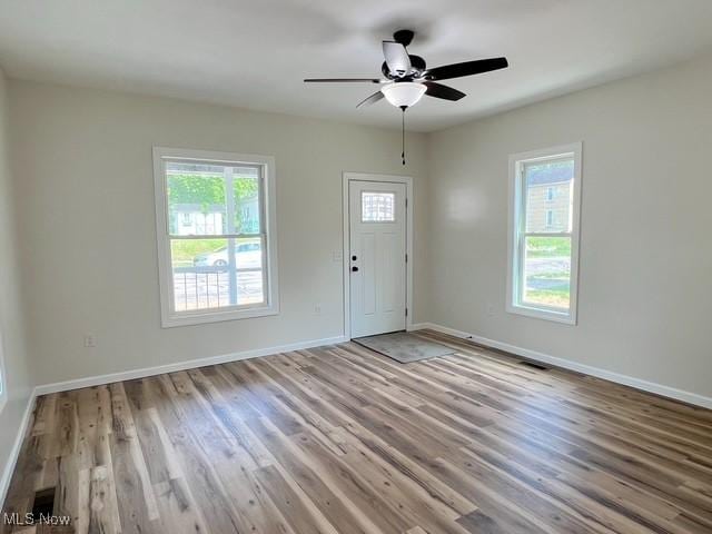 619 N 3rd St, Dennison, OH 44621 - entrance foyer featuring healthy amount of natural light, wood finished floors, and ceiling fan