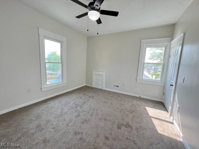 619 N 3rd St, Dennison, OH 44621 - spare room featuring plenty of natural light, ceiling fan, and carpet