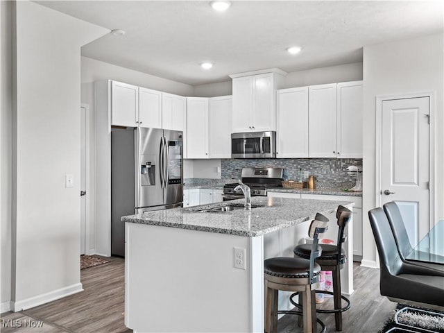 3243 Broadleaf Way, Brunswick, OH 44212 - kitchen featuring stainless steel appliances, wood finished floors, white cabinets, and recessed lighting