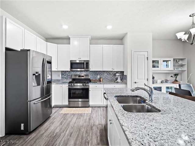 3243 Broadleaf Way, Brunswick, OH 44212 - kitchen with stainless steel appliances, white cabinetry, light wood-style flooring, light stone counters, and recessed lighting