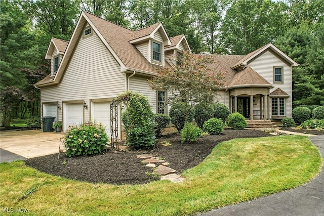 1681 State Rd, Warren, OH 44481 - view of front of property with a garage, a shingled roof, driveway, and a front yard