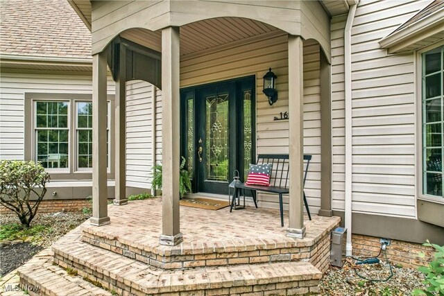 1681 State Rd, Warren, OH 44481 - doorway to property with covered porch and a shingled roof